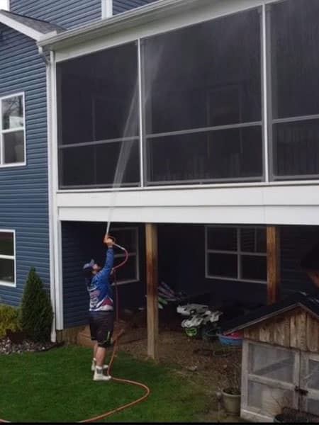 A Pressure Washer Performing House Washing Services