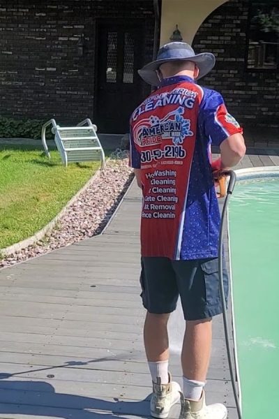 Pressure washer performing pressure washing on a deck